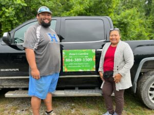 Andy Ordaz stands beside Rosalina Nuñez in front of their farm truck.