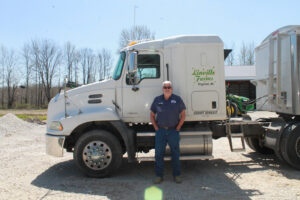 Chris Linville stands in front of his truck.