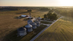 Aerial photo of a farm with grain bins in the foreground