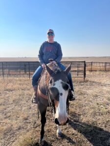 Caitlin riding a horse